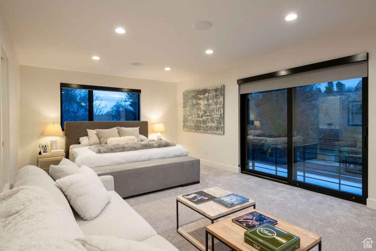 A luxurious bedroom with a king-size bed and a private balcony.