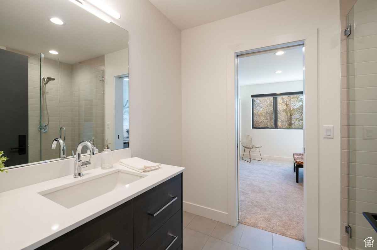 A modern bathroom with a spacious vanity and glass shower.