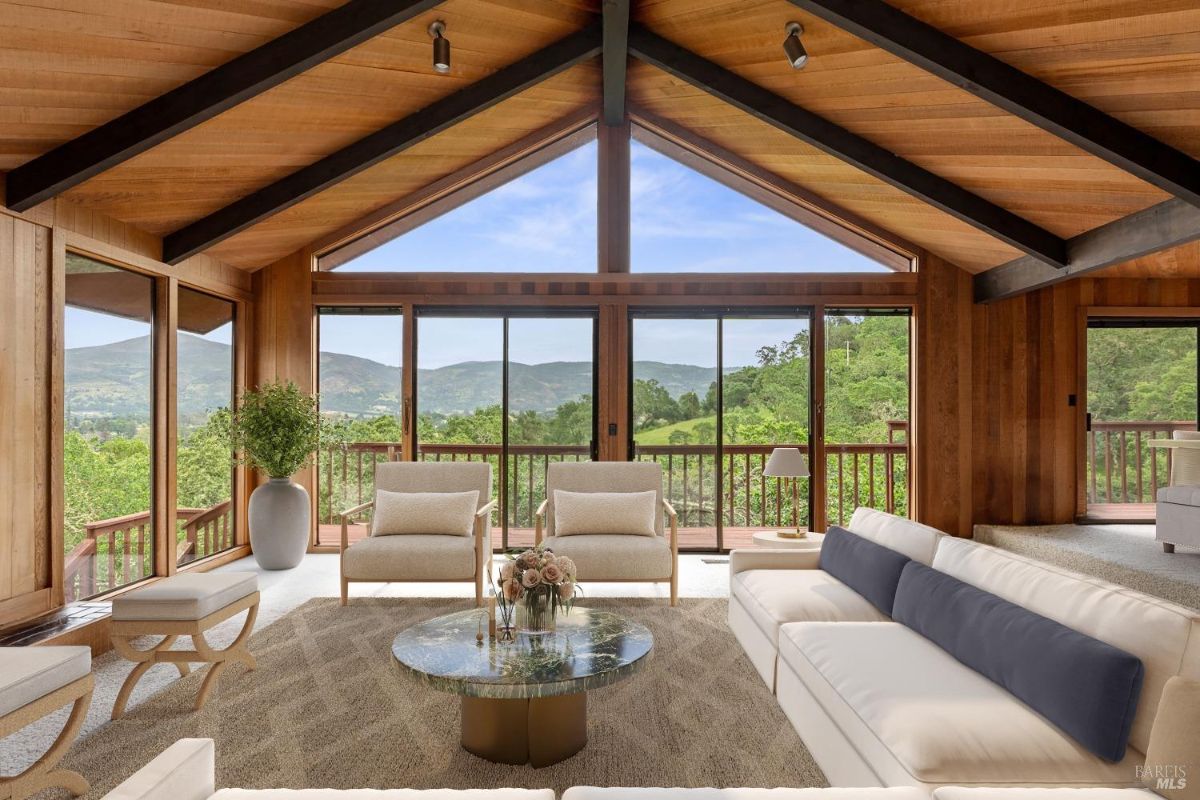 Open living area showcasing stunning views through expansive windows and elegant, minimalist decor.