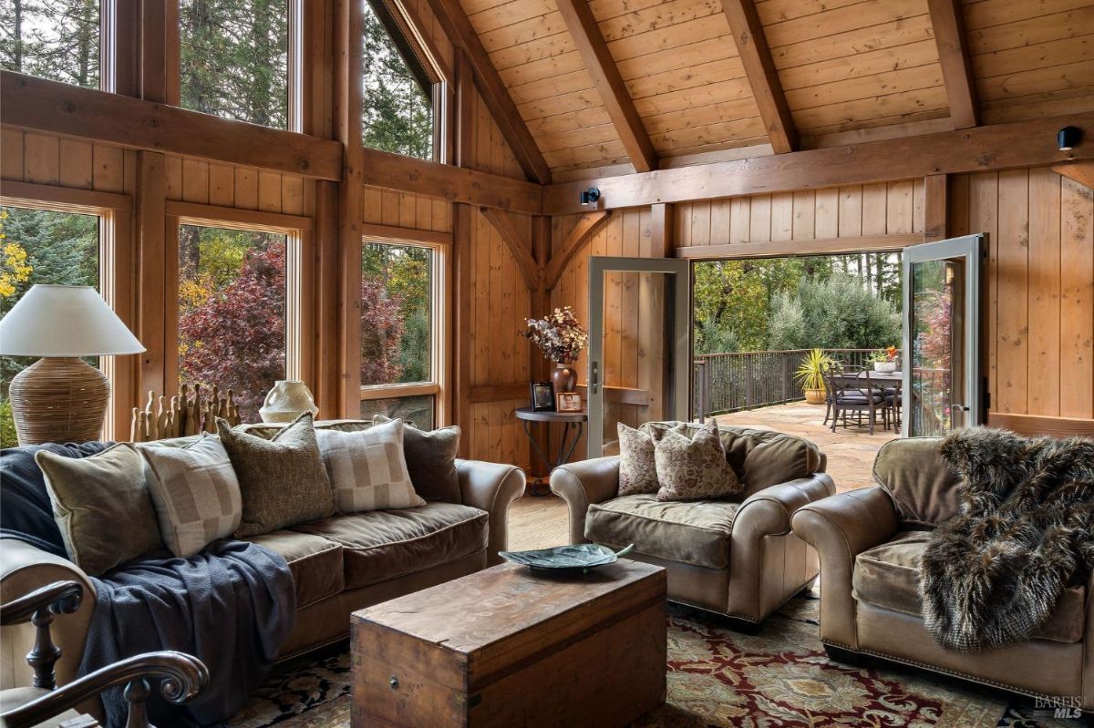 Cozy sitting area with plush armchairs and a wooden coffee table near open patio doors.
