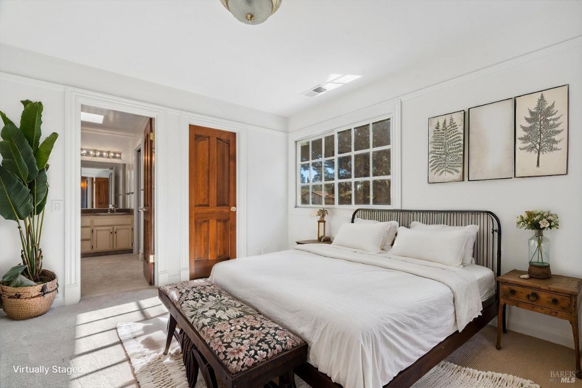 Bedroom with a simple layout, large window, and neutral-toned decor.