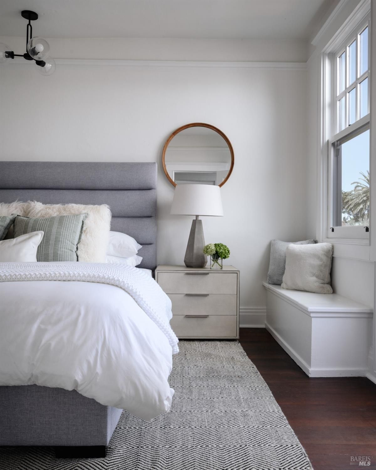 Bedroom with a vaulted ceiling, a four-poster bed, a sitting area, and a balcony with a view.