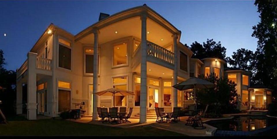 Elegant Two-Story Villa with Majestic Columns and Warm Lighting