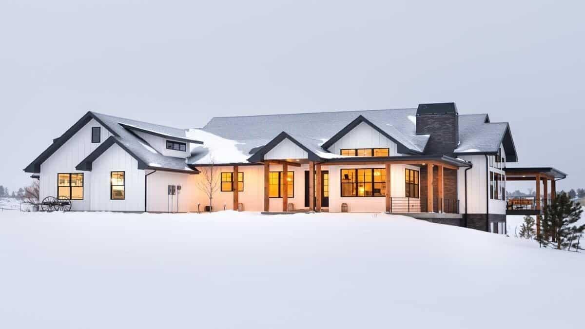 Modern Farmhouse with Striking Black Trim Against the Snow