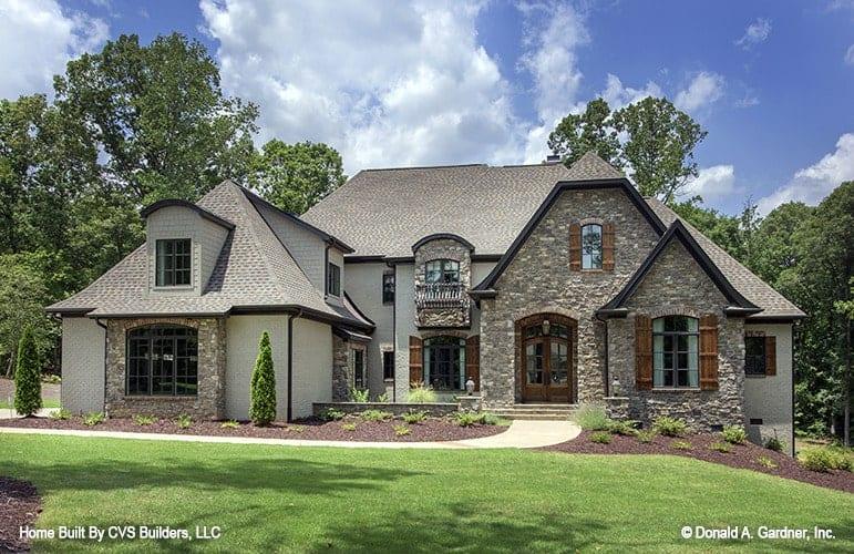 French Country Charm with Stone Facade and Dormer Windows