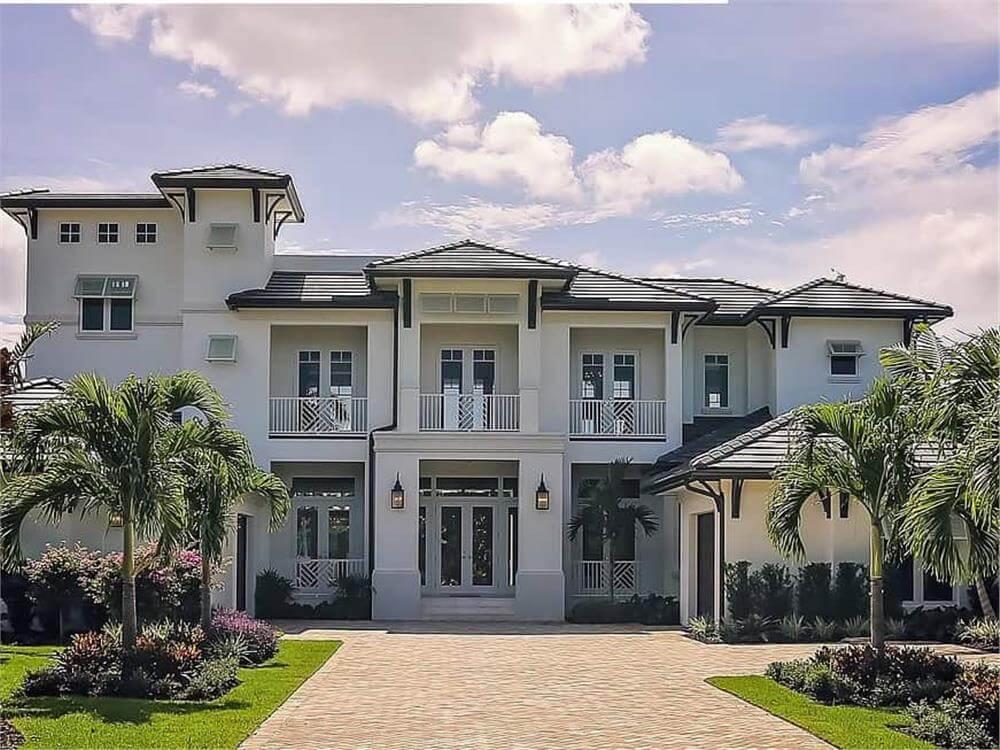 Modern Coastal Home with Striking Symmetry and Palm-Lined Driveway