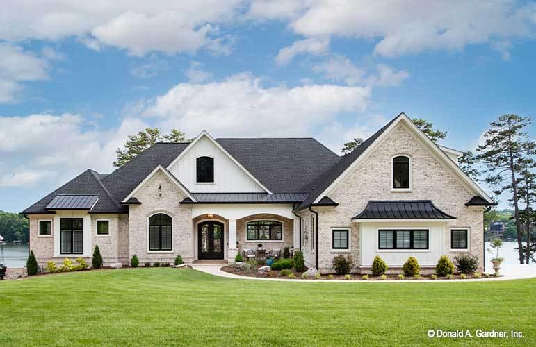 Charming Lakeside Home with Brick Facade and Arched Entryway