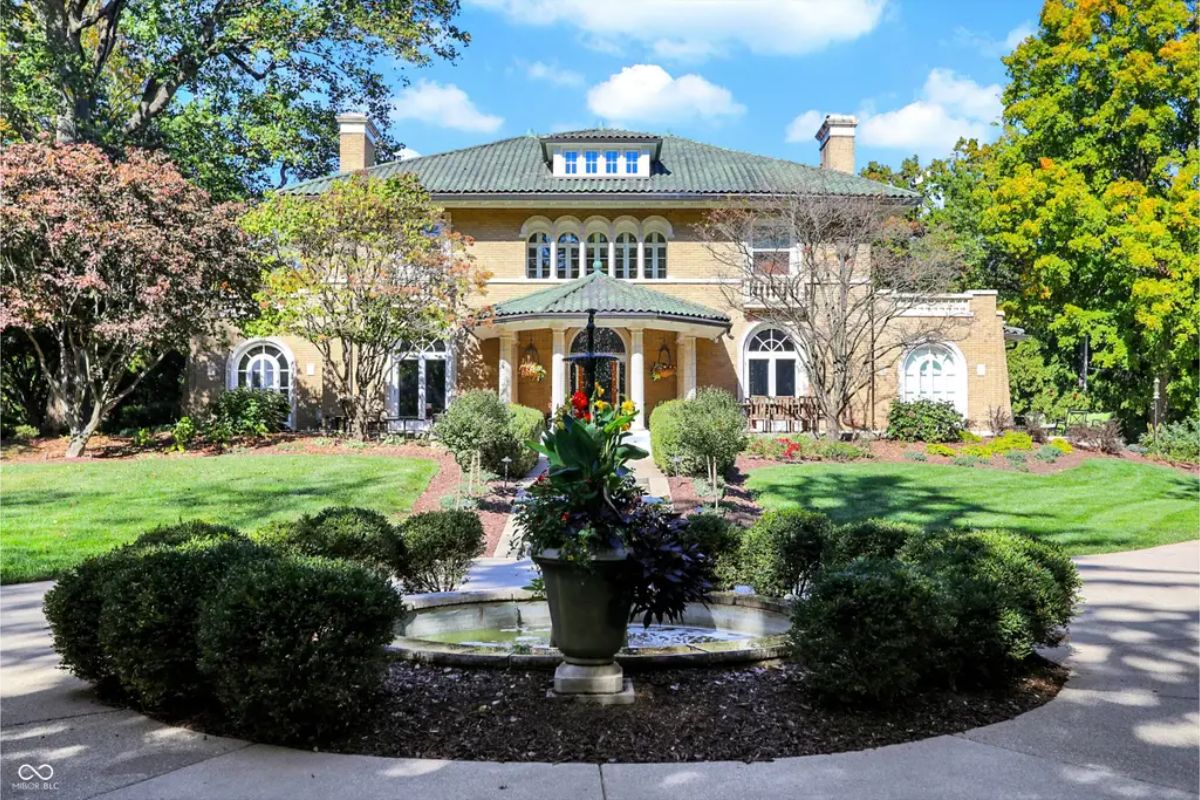 Italianate-style estate built in 1917, situated on a 1.75-acre property with dual drives, terraced outdoor spaces, and century-old trees.