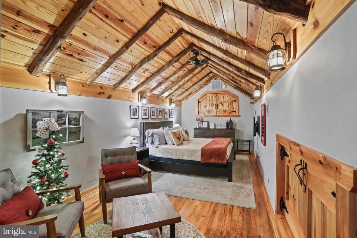 Vaulted wooden ceiling highlights the cozy bedroom with rustic charm.