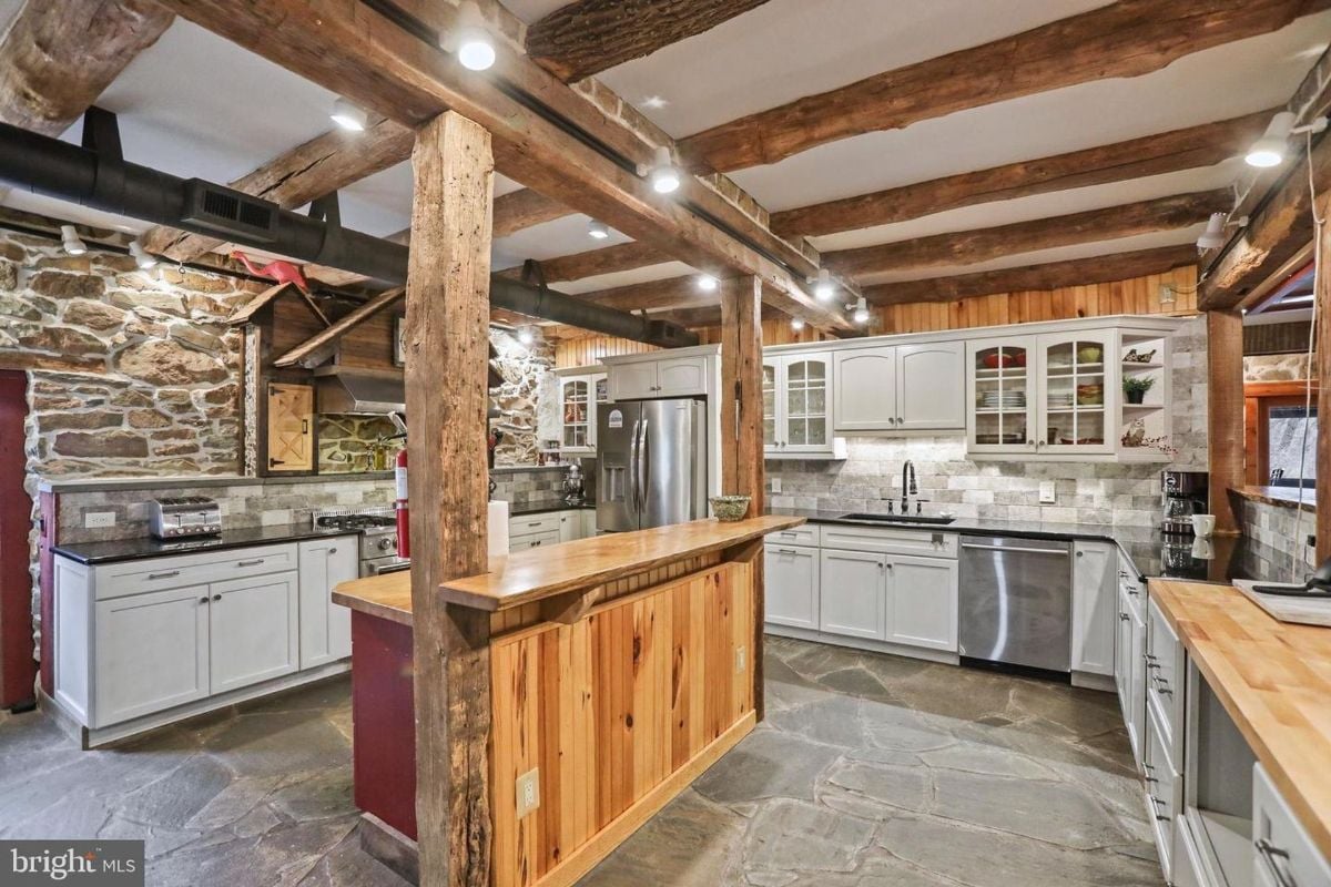 Kitchen with a central wooden island and custom cabinetry.