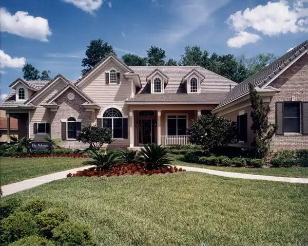 Classic Suburban Home with Symmetrical Dormers and Brick Facade