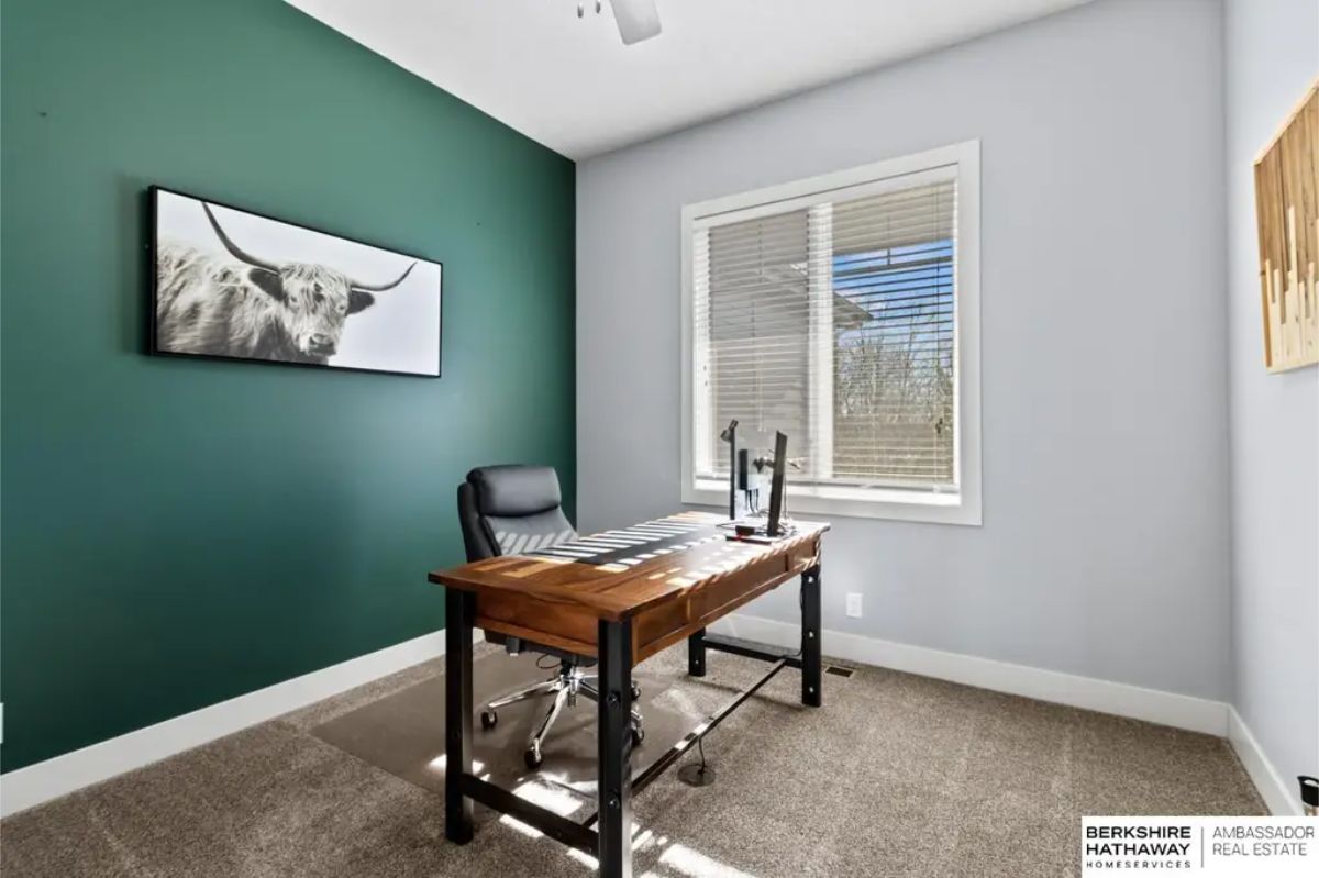 Compact and functional office space with large windows allowing ample sunlight to brighten the room.