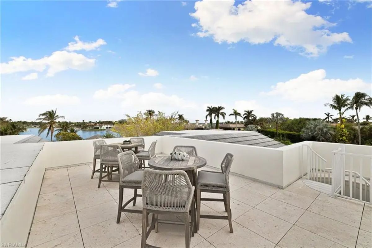Rooftop patio with outdoor seating and dining set, providing a panoramic view of the surrounding area. 