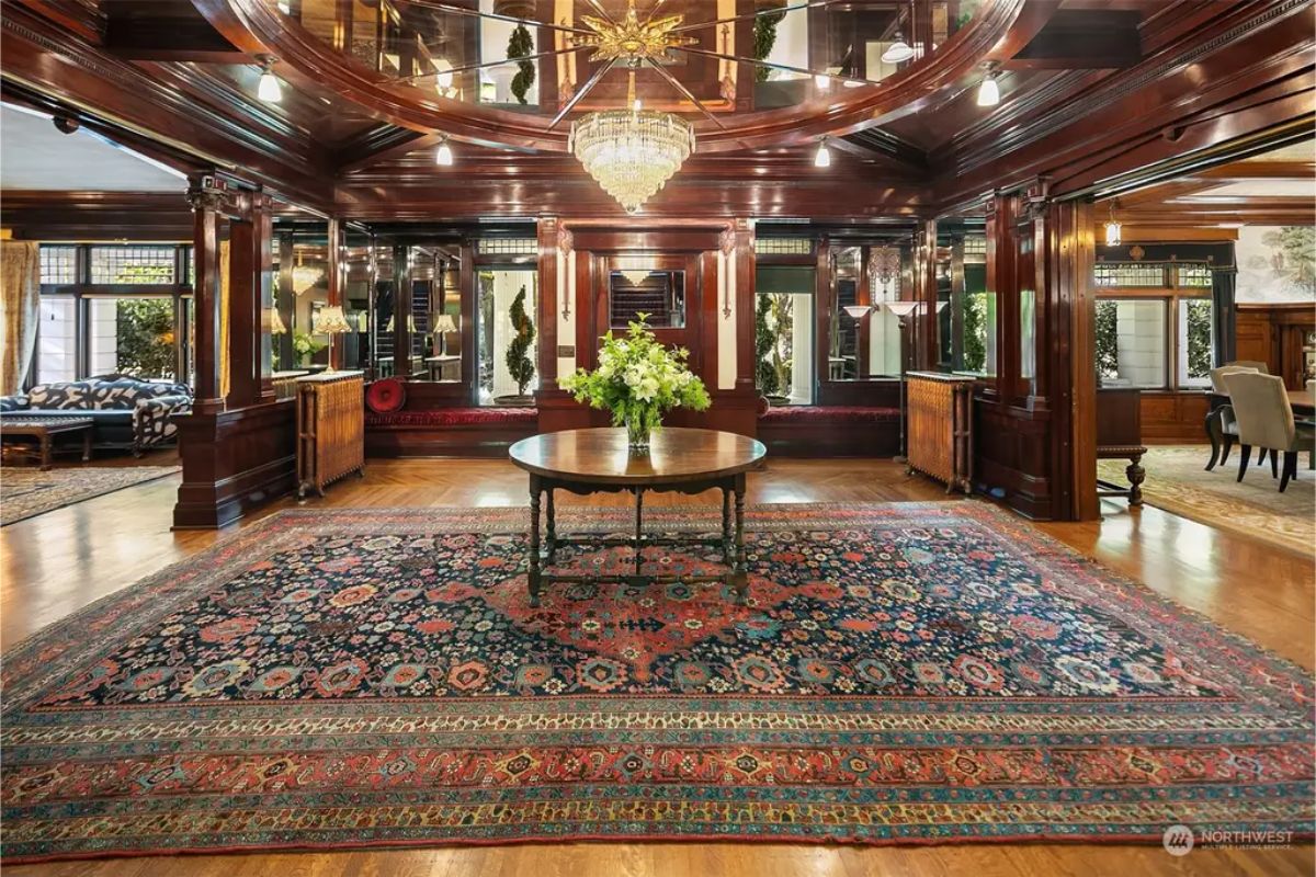 Central hallway features mirrored walls and rich wood paneling.