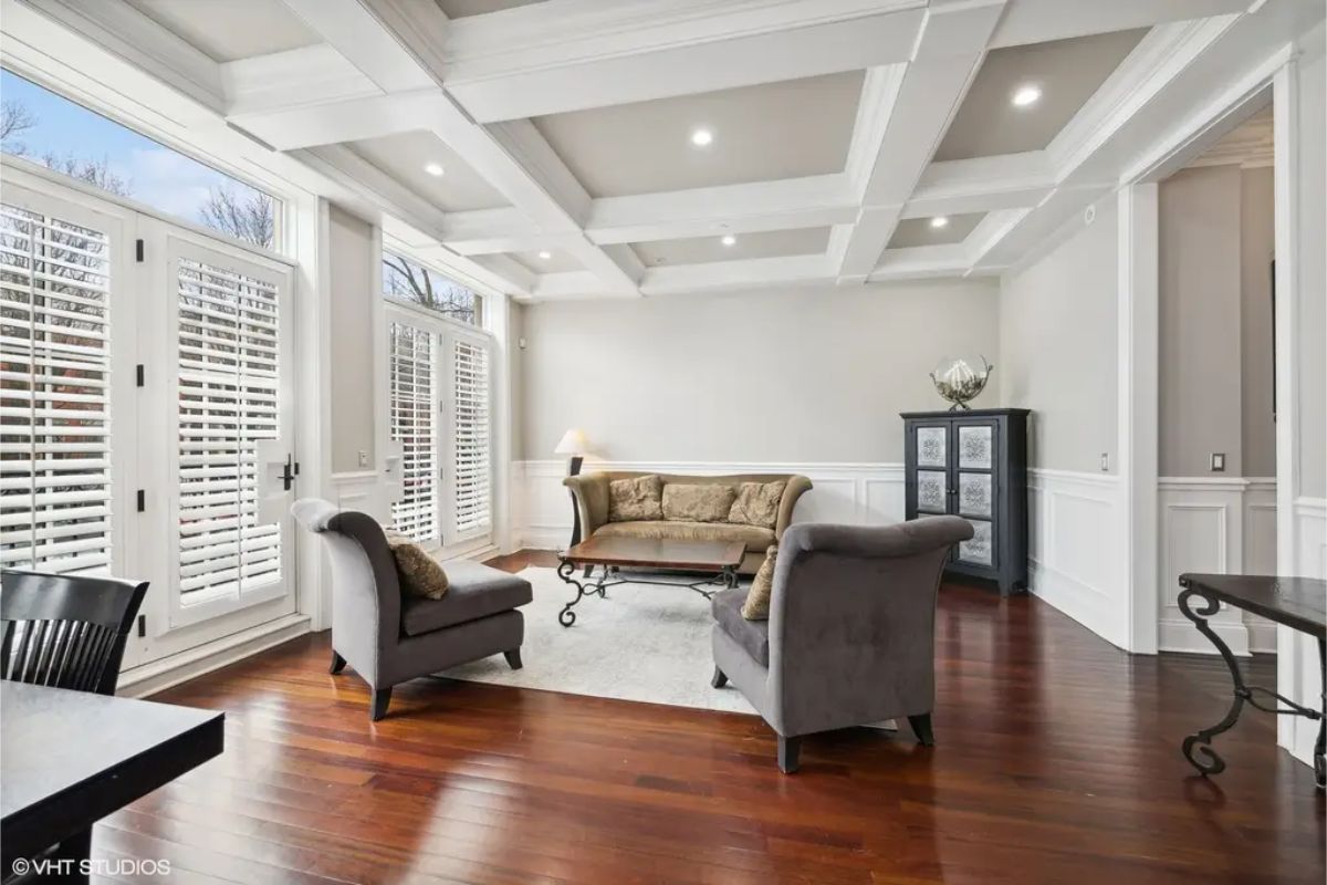 Large windows and plantation shutters allowing ample natural light.
