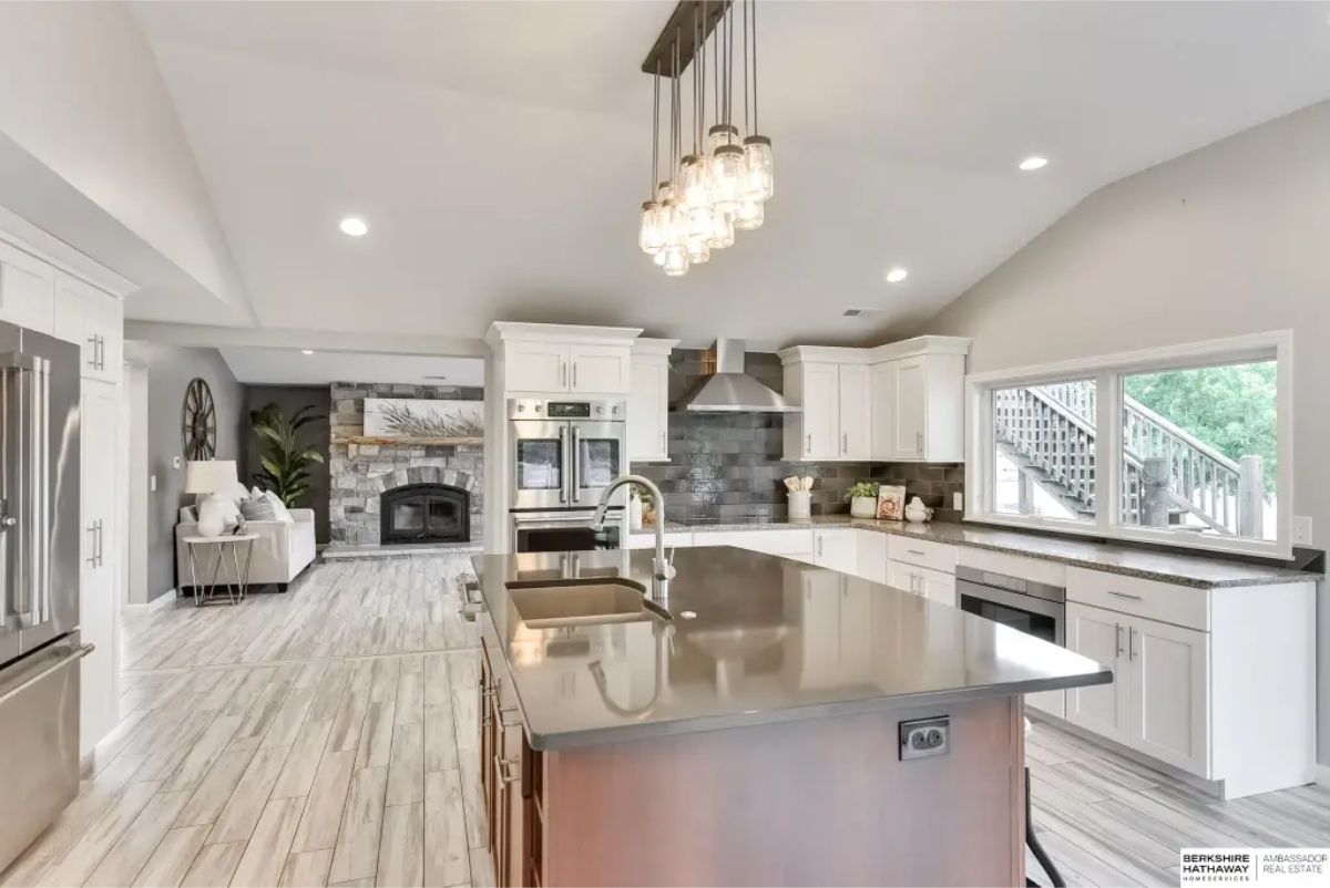 A large central island with a sleek countertop and built-in sink.