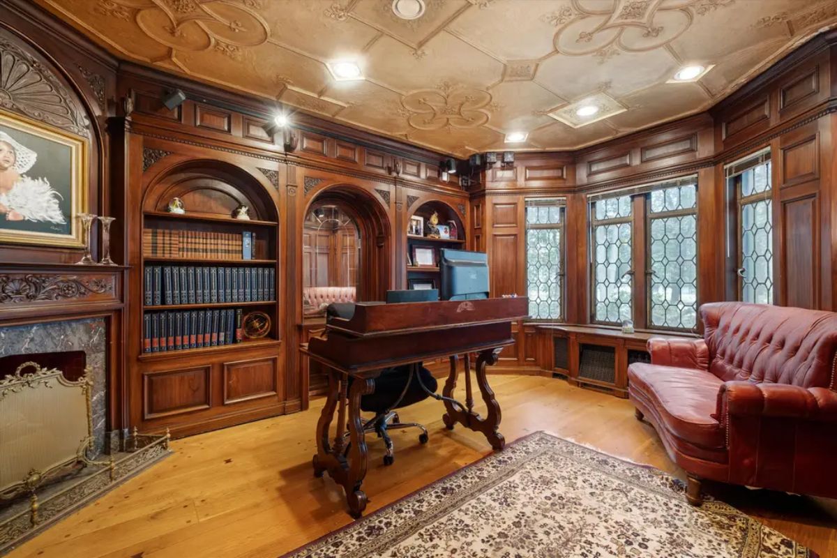 Wood paneling and built-in shelving for books and decorative items.
