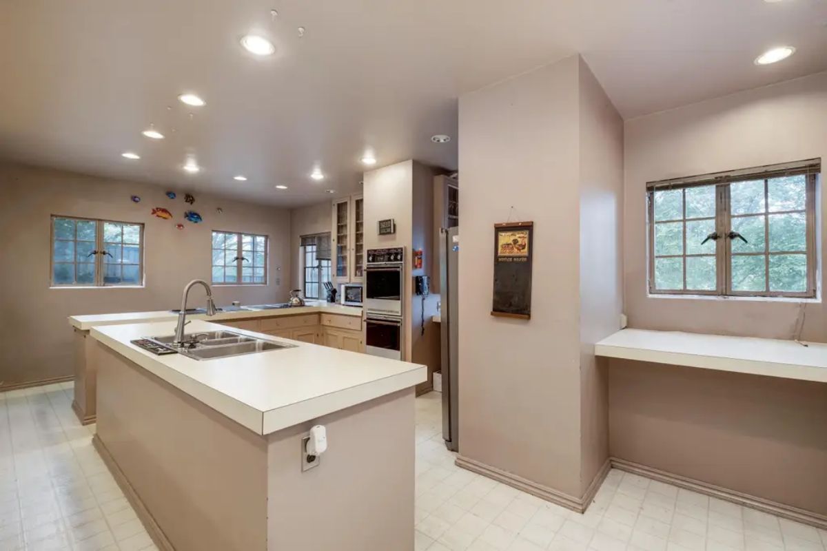 Offers an open layout with ample natural light streaming through multiple windows.
