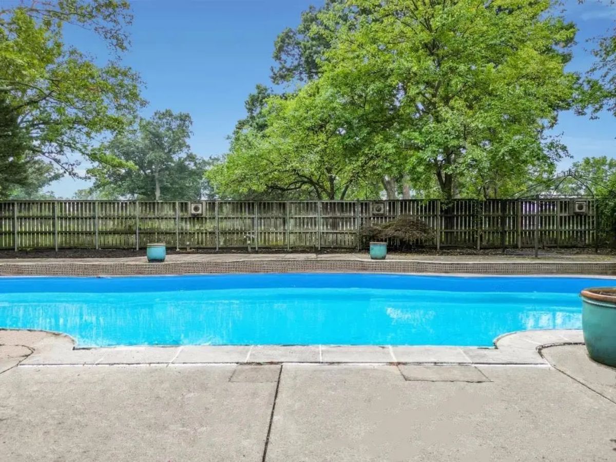 Rectangular swimming pool surrounded by a concrete deck.