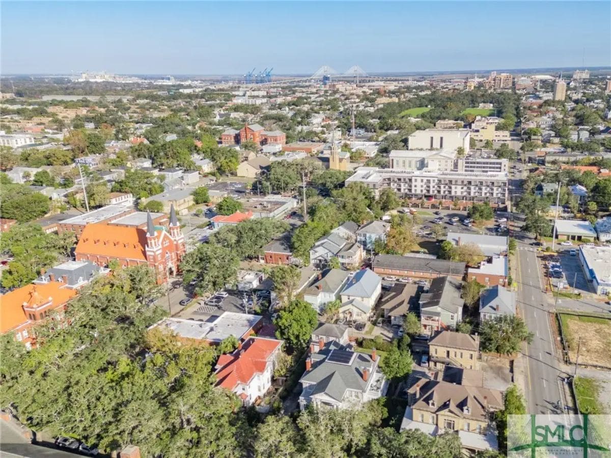 Expansive aerial view showcasing a vibrant historic district with tree-lined streets and diverse architecture.