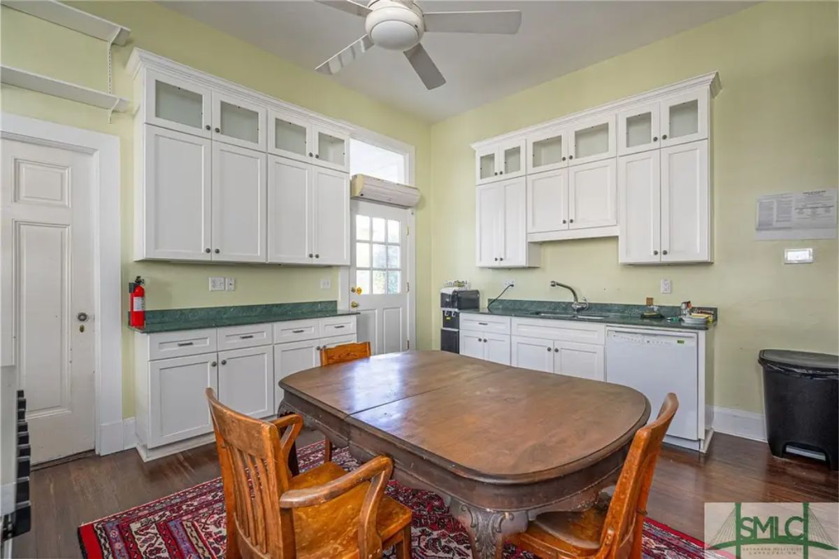 Kitchen with white cabinets extending to the ceiling for ample storage and a clean, bright look.