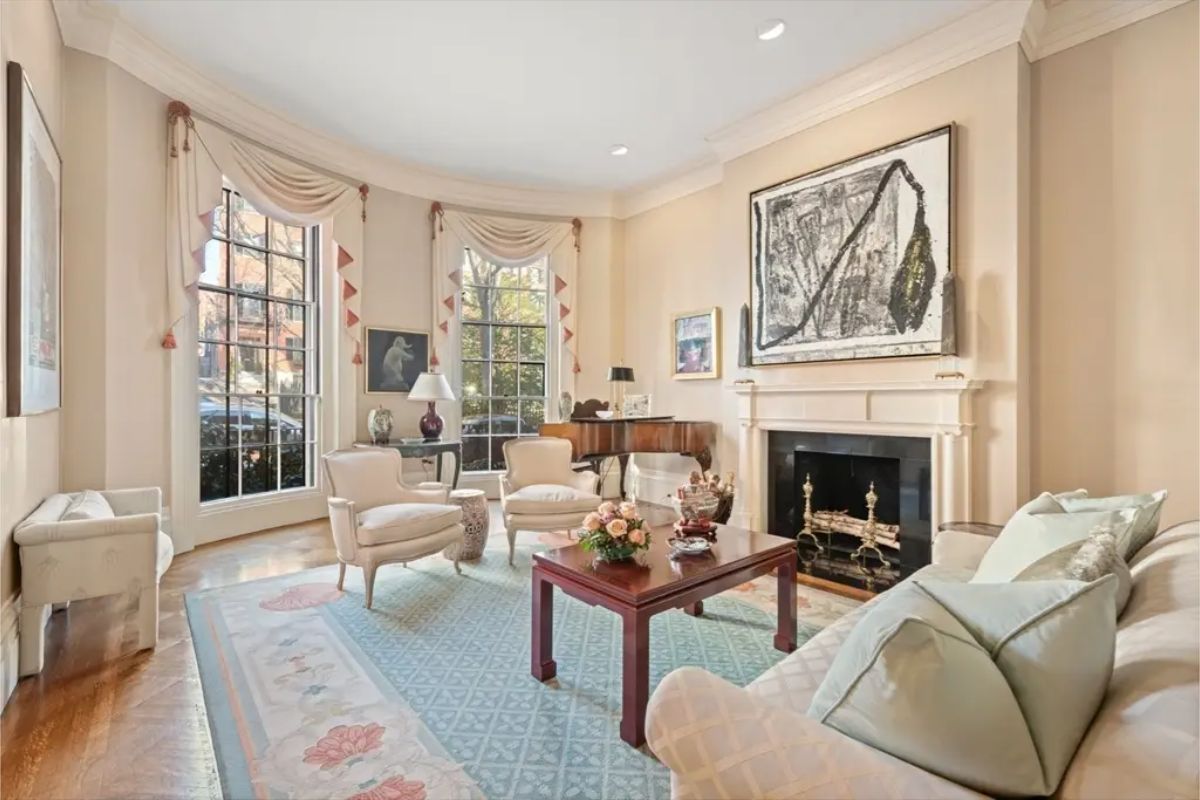 This refined living room features large windows dressed with classic drapery, allowing ample natural light to fill the space.