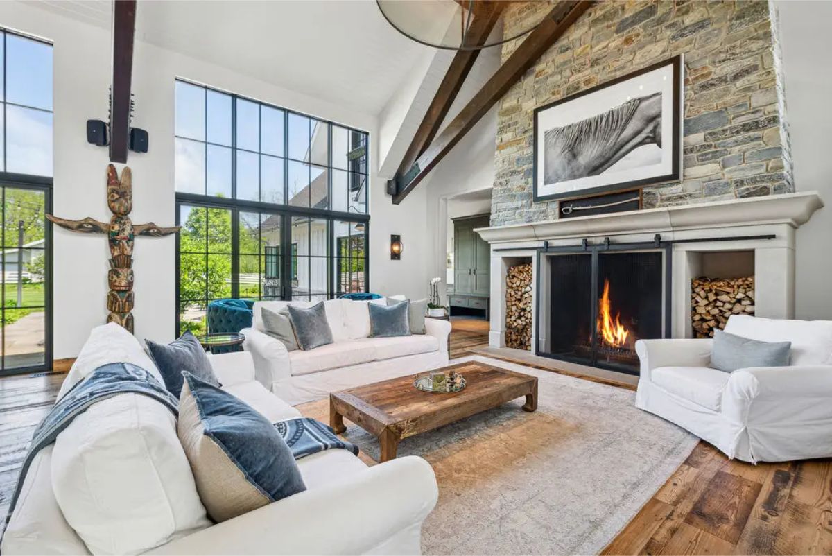Living room showcases a 28-foot vaulted ceiling with exposed beams and floor-to-ceiling windows.