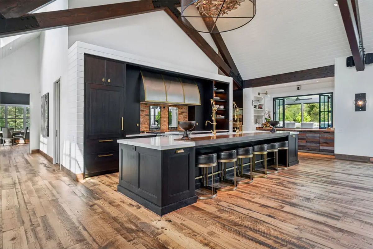 Expansive chef's kitchen with a bold, modern design centered around a 16-foot island featuring white granite countertops.