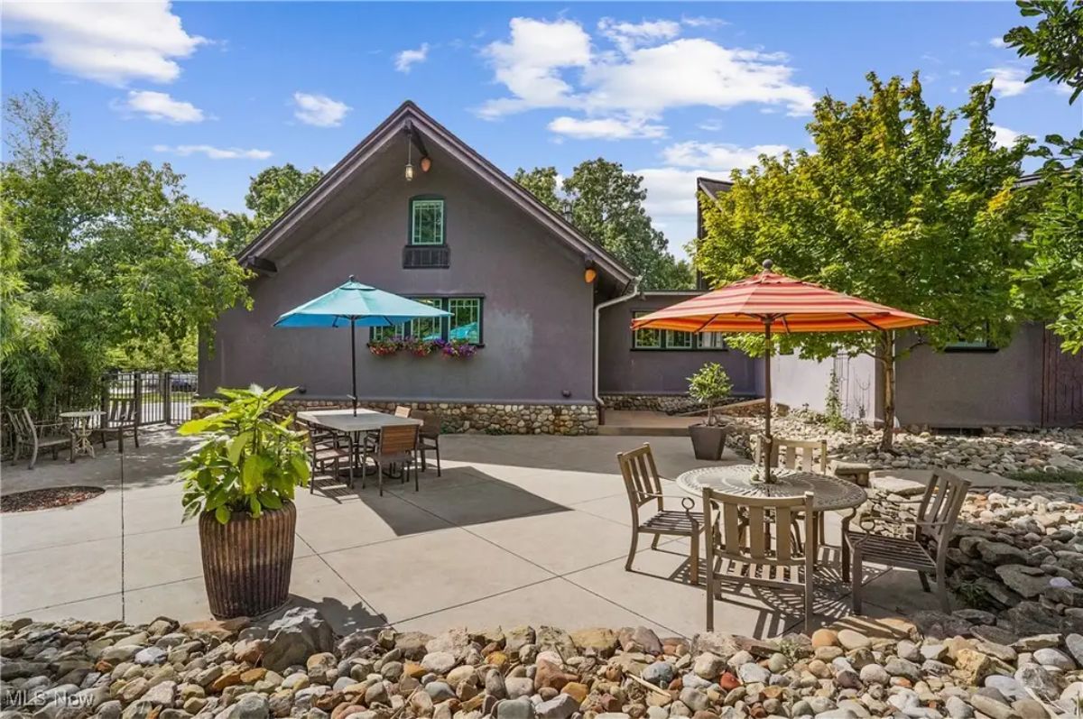 Multiple seating areas with colorful umbrellas, creating inviting spots for dining and relaxation.