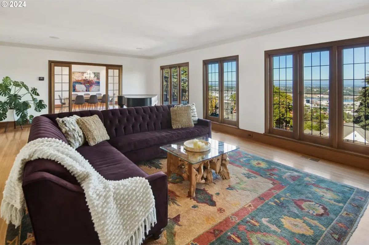 Large wood-framed windows offering panoramic views of the landscape.