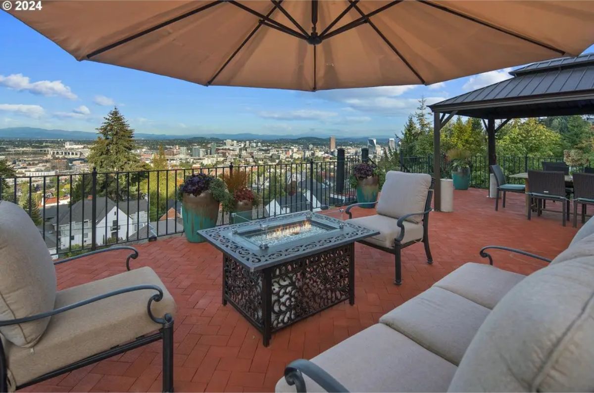Outdoor patio offers panoramic views of the city skyline and surrounding landscape.