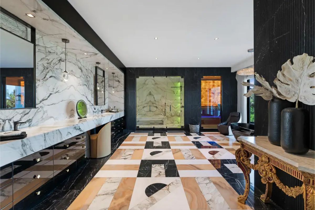 Modern and sleek bathroom with black, white, and beige marble finishes, featuring a long vanity and stylish decor. 