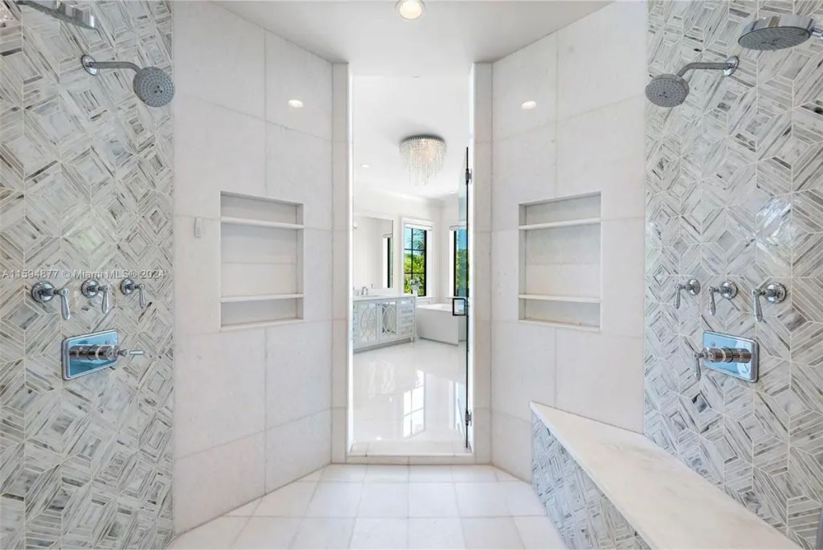 Laundry room includes modern appliances, extensive cabinetry, and a bright, clean design. 