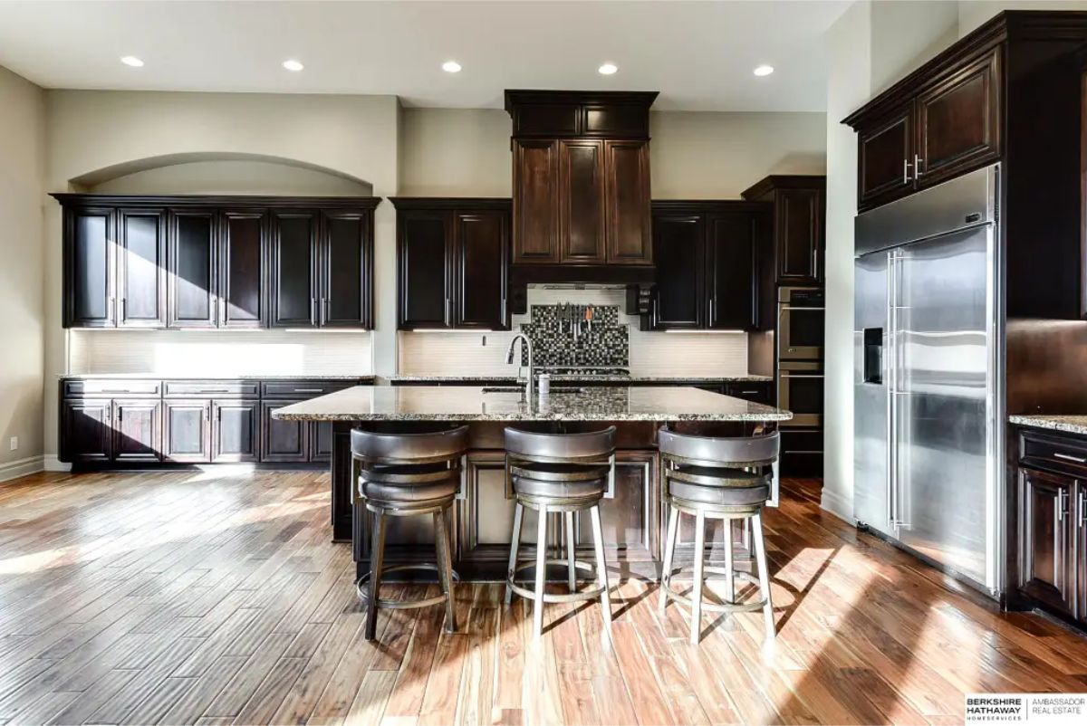 Dark wood cabinetry extending to the ceiling for maximum storage.