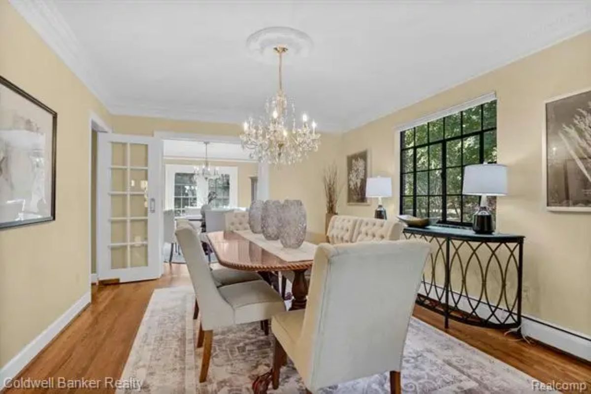 Dining room with central chandelier adding a touch of sophistication.