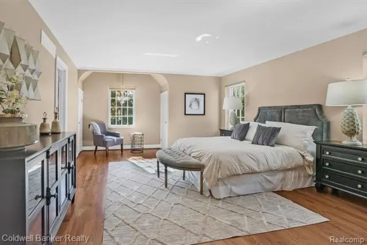 Bedroom offers ample natural light through multiple windows, creating an inviting atmosphere.