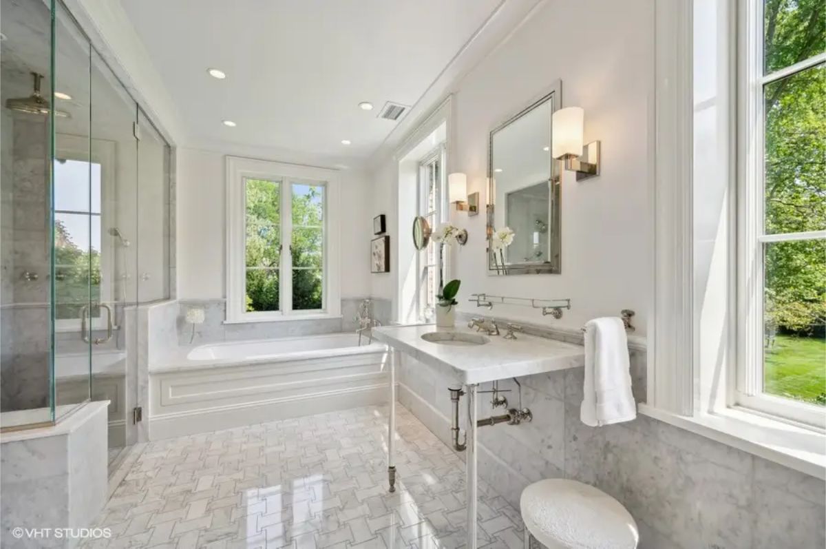 Large windows offering natural light and views of lush greenery.
