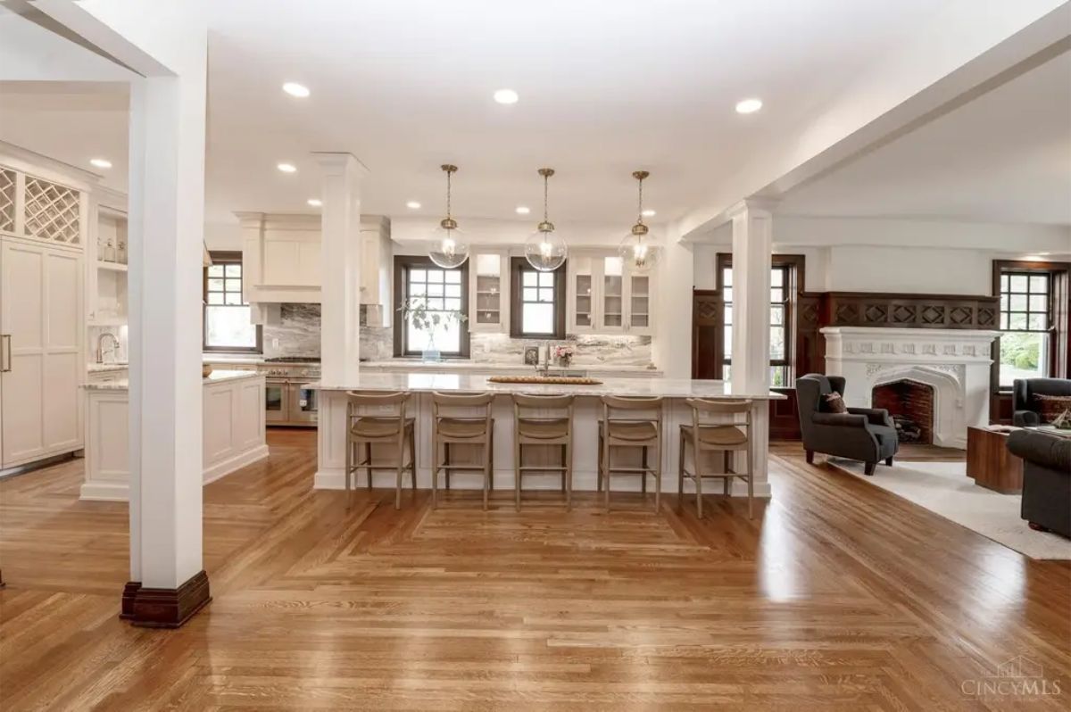 A spacious kitchen with a large central island provides seating for six and ample workspace.