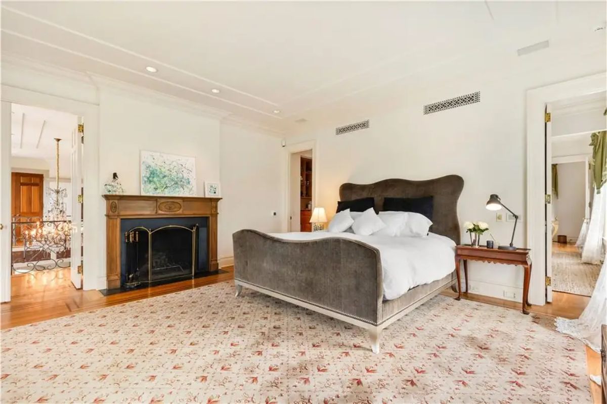 Stylish bedroom featuring a mix of contemporary and vintage design elements with luxurious detailing. 