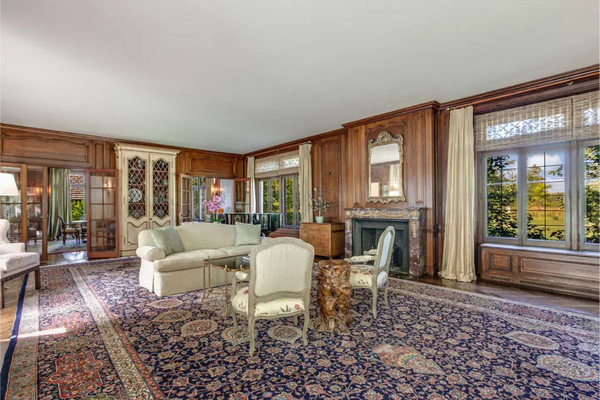Rich wood-paneled walls and large windows offering natural light and outdoor views.