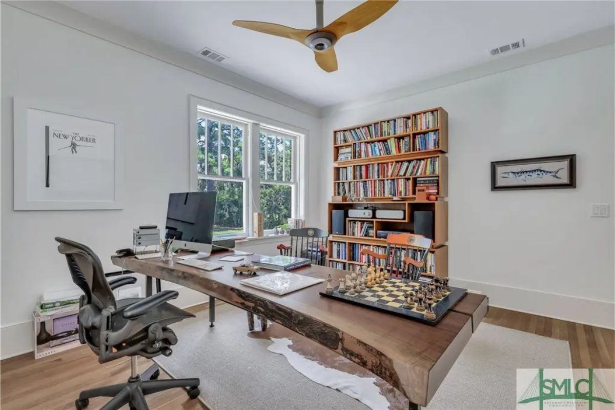 Large, live-edge wooden desk with a natural finish, complemented by a modern ergonomic chair.