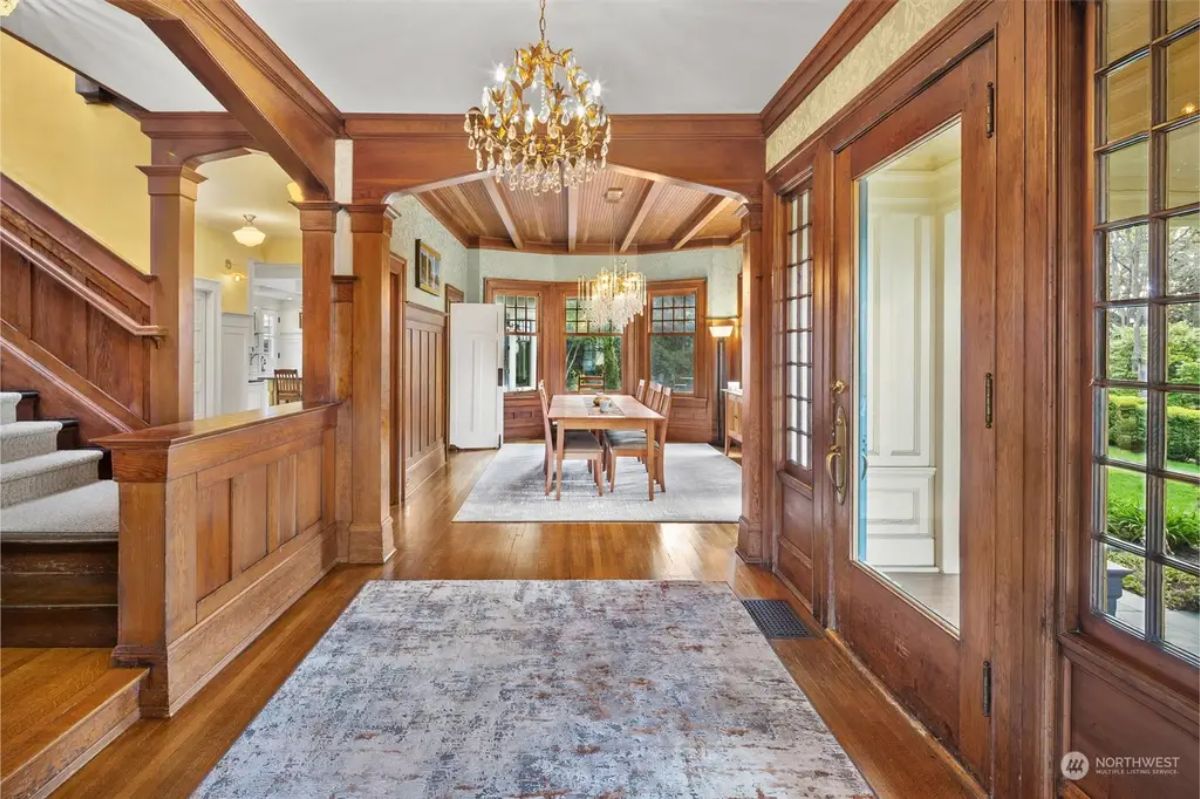 Hardwood flooring, rich wood paneling, and detailed trim showcase early 20th-century craftsmanship.