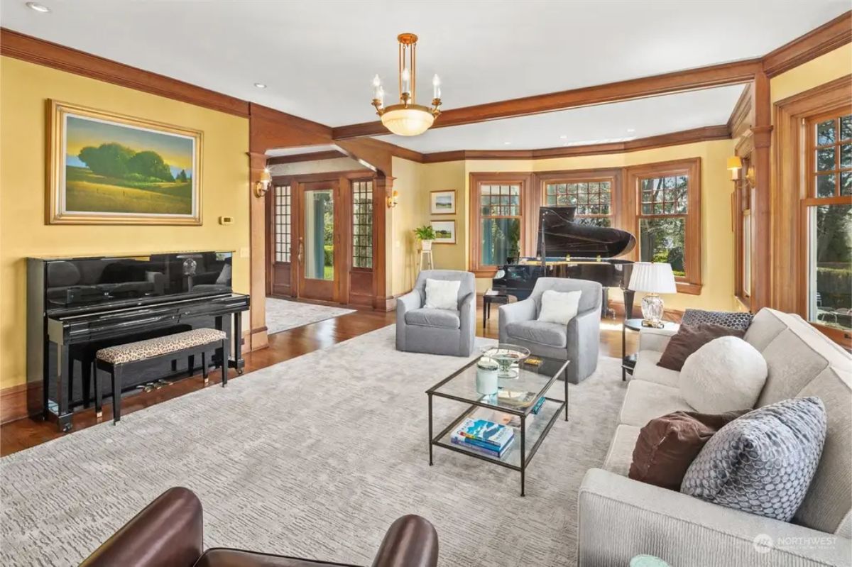 Living room with large bay windows and custom wood trim.