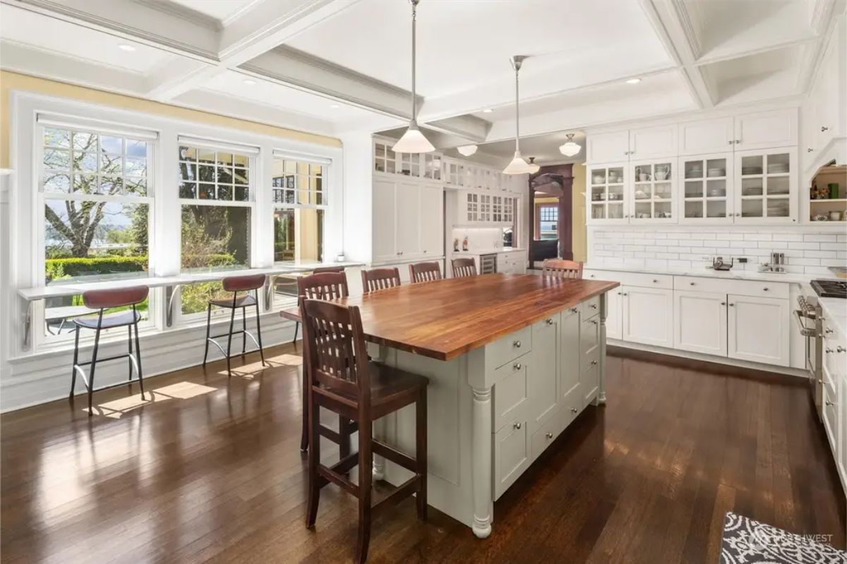 Kitchen with a large wooden-topped island with seating.