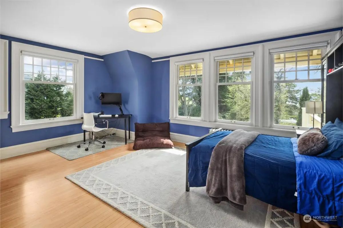 Room features bold blue walls paired with crisp white trim.
