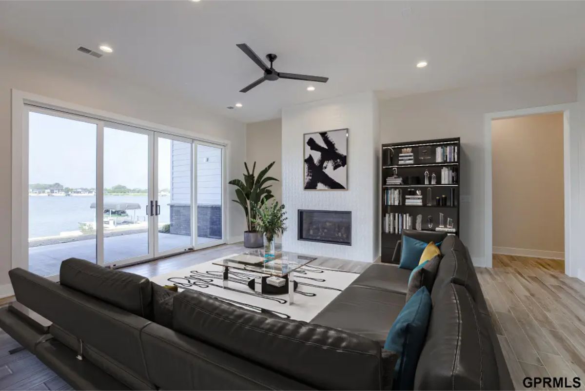 Living room designed with expansive sliding glass doors offering stunning views of the lake.