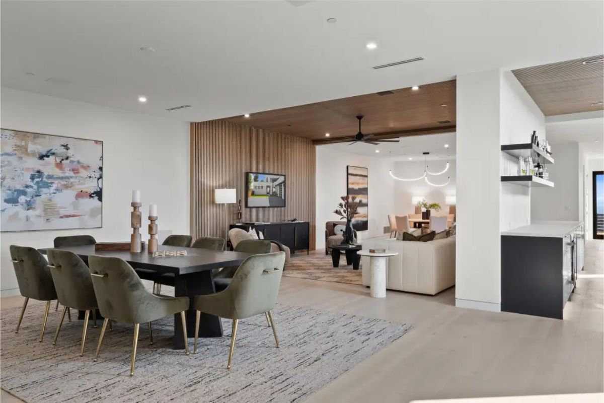 Dining and living areas showcasing contemporary design and wood panel accents. 