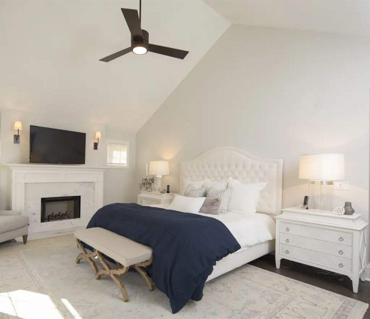 Spacious bedroom designed with a vaulted ceiling and a clean, neutral color palette.