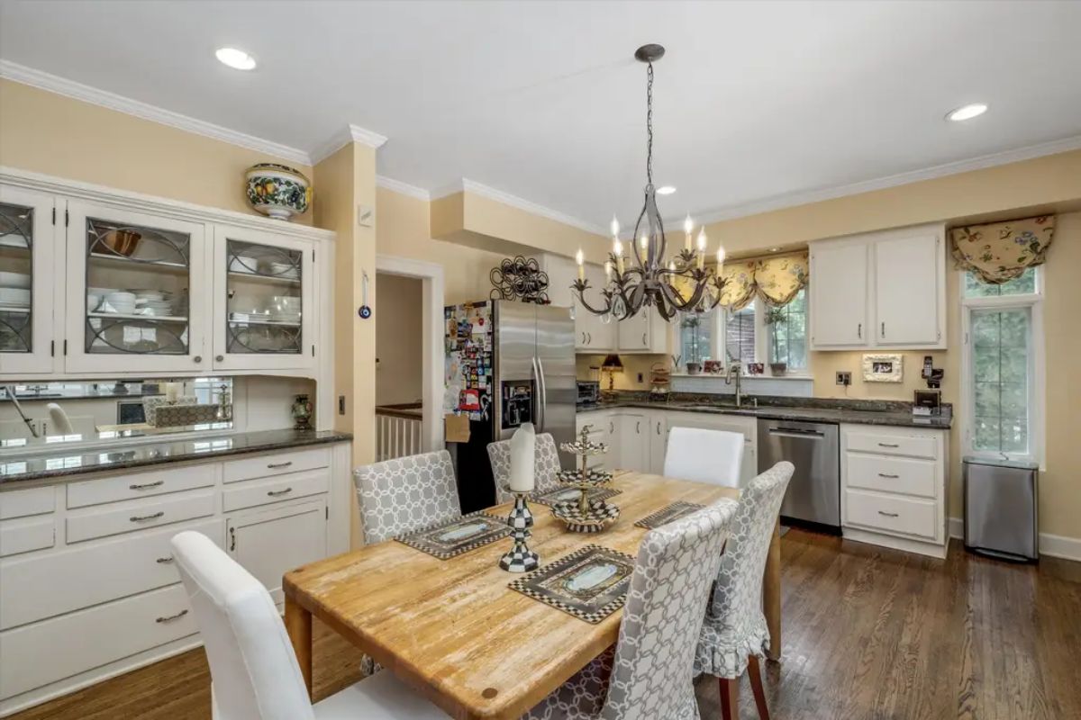The kitchen and dining space is designed with light tones and abundant natural light.