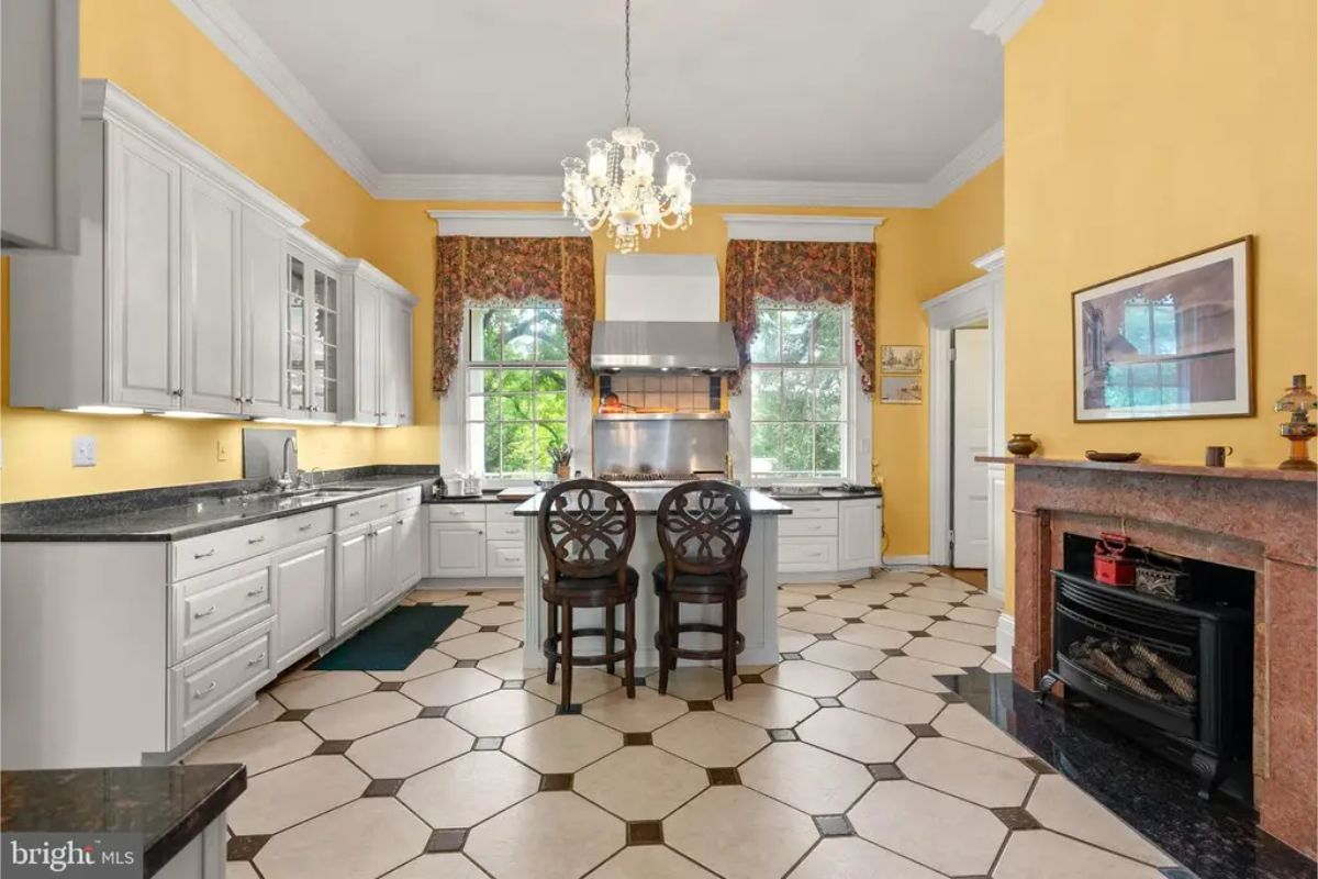 White cabinetry, black granite countertops, and stainless steel appliances.
